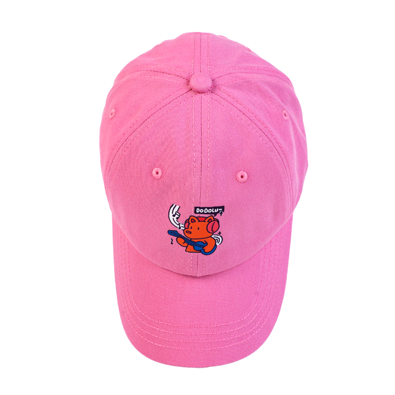 Pink custom baseball cap with cartoon pig graphic and playful doodle design on front.