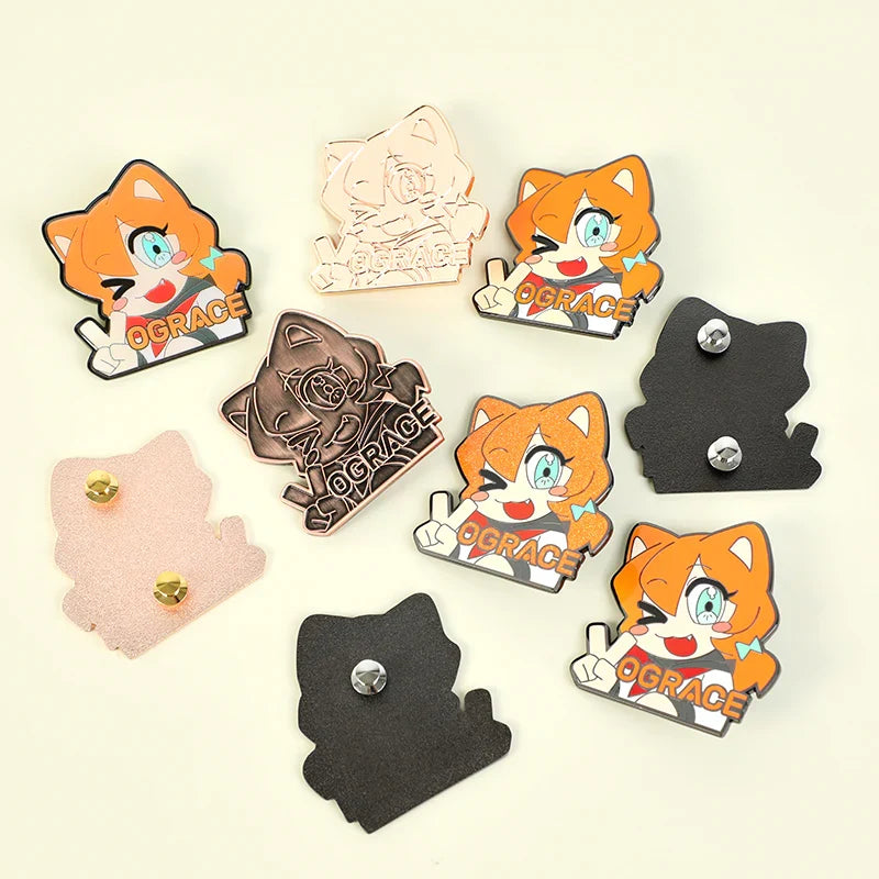 Custom enamel pins featuring winking orange cartoon cat design with metal backings