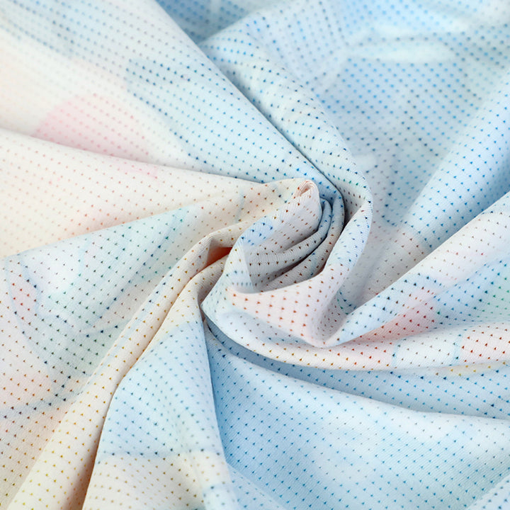 Close-up of lightweight, quick-dry fabric with pastel print and small perforations
