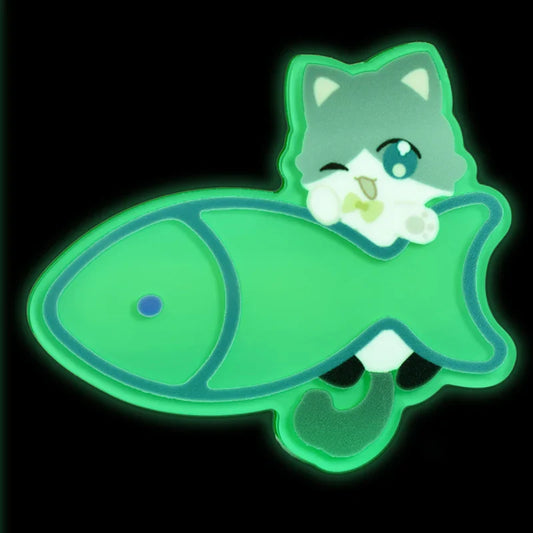Glow in the dark acrylic hair clip featuring a winking cartoon cat with a green fish.