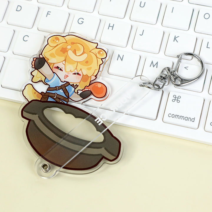 Custom multi-layer acrylic keychain with cute anime character and cooking pot on a keyboard