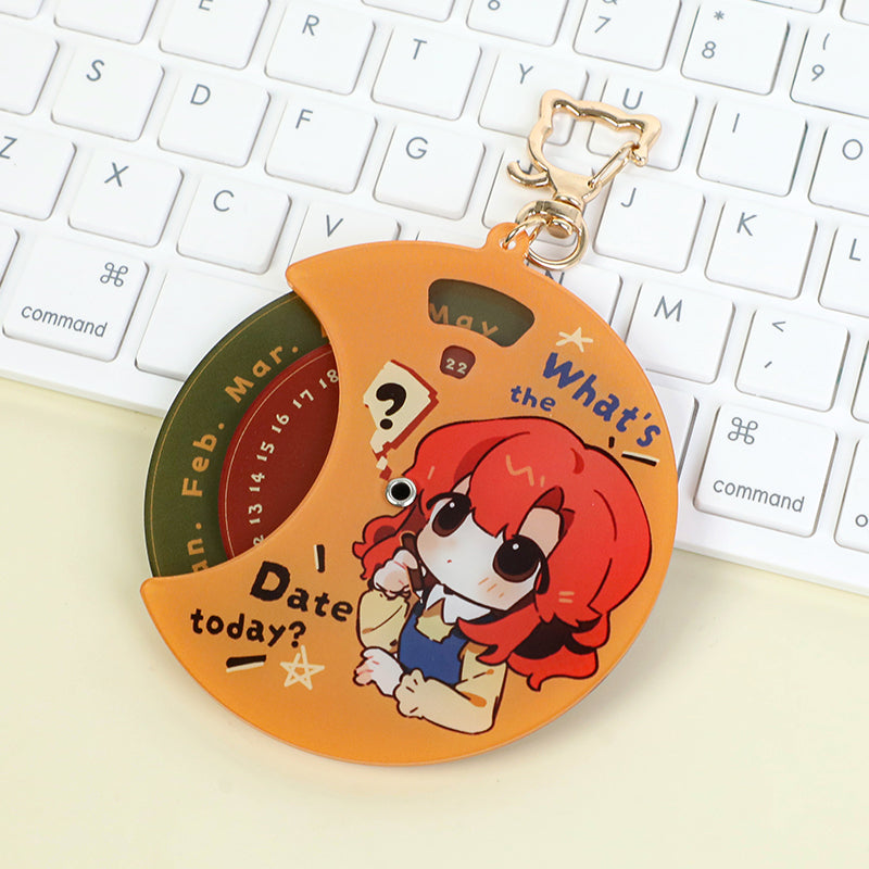 Custom multi-layer acrylic keychain with anime girl design and rotary calendar, on keyboard.