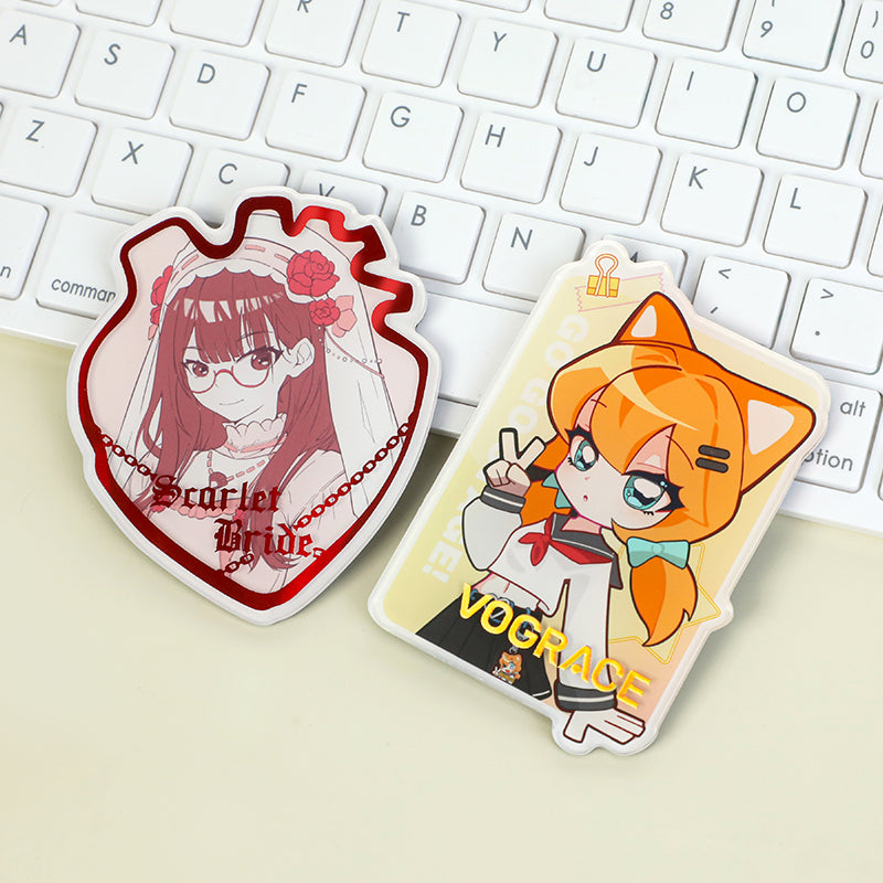 Custom acrylic anime fridge magnets with raised foil stamping on a white keyboard