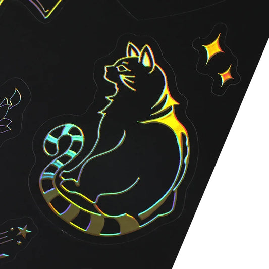 Custom raised foil cat sticker with holographic effect on a black sticker sheet